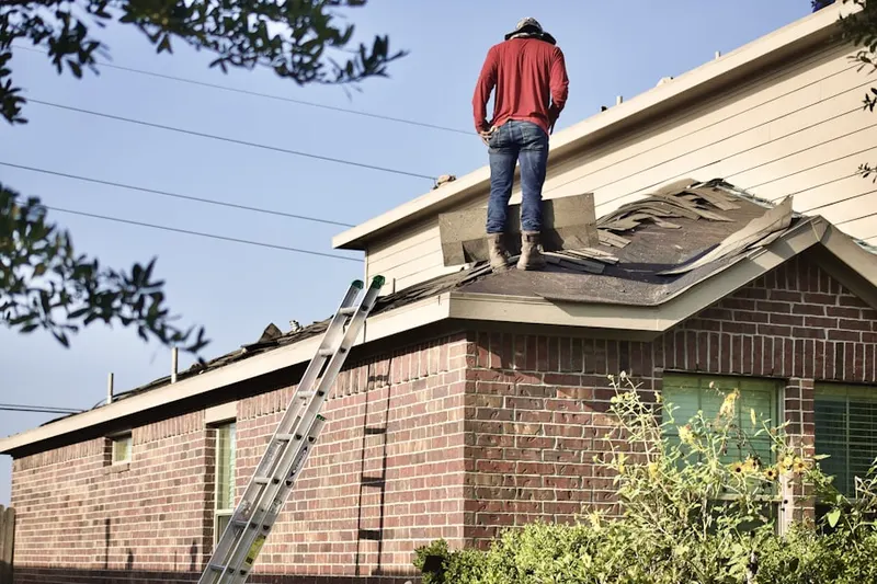 Professional roofer working on a residential roof in Runnemede